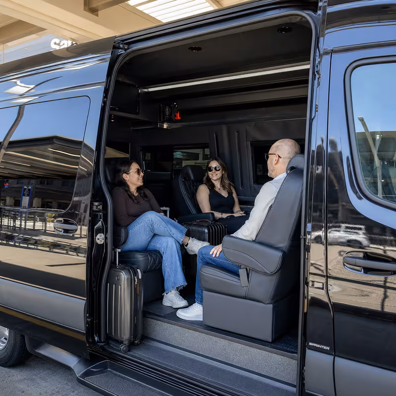 Passengers loading luggage while boarding an San Diego group shuttle
