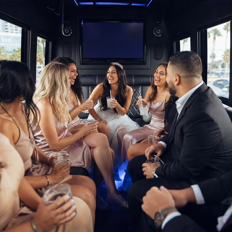 Party bus interior with wraparound leather seating and LED lighting in San Diego