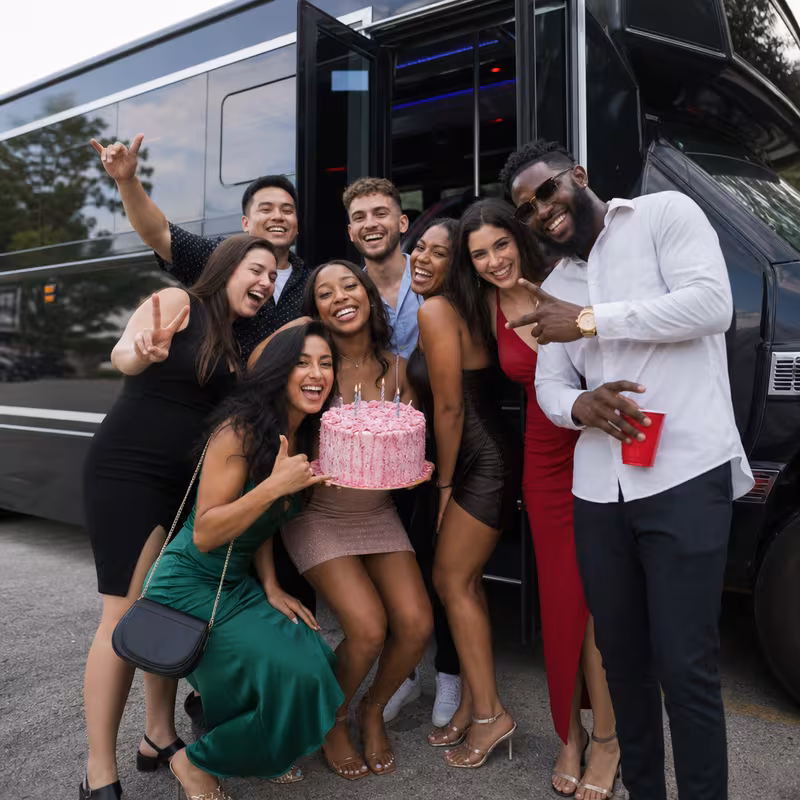 Group boarding a white charter bus for Birthday Transportation transportation in San Diego