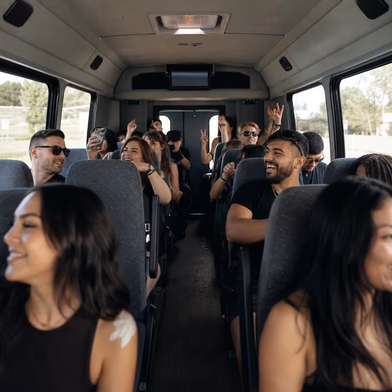 Party bus interior with wraparound leather seating and LED lighting in San Diego