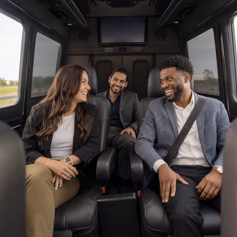Group boarding a white charter bus for Corporate Transportation transportation in San Diego
