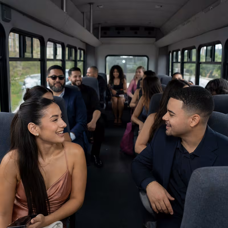 Group boarding a white charter bus for Private Event Transportation transportation in San Diego