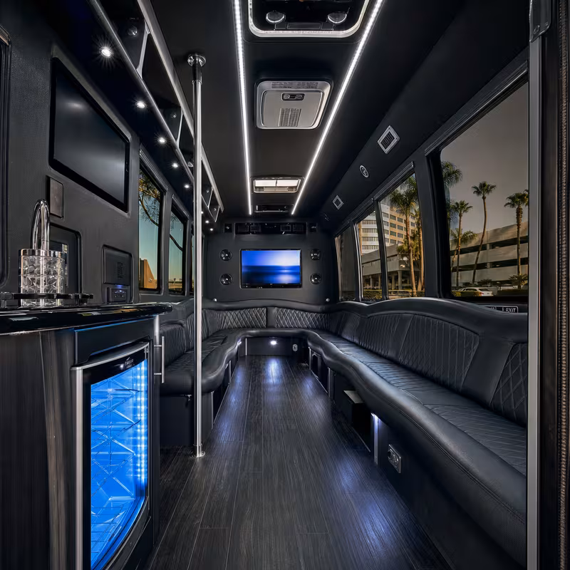Party bus interior with wraparound leather seating and LED lighting in San Diego