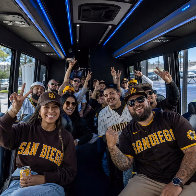 Group boarding a white charter bus for Sporting Event Transportation transportation in San Diego