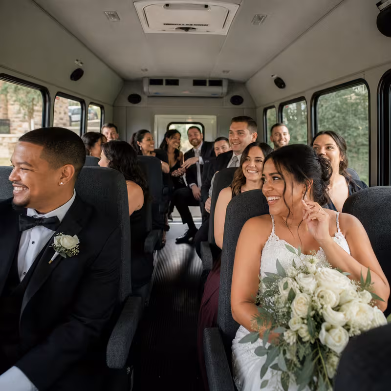 Group boarding a white charter bus for Wedding Transportation transportation in San Diego
