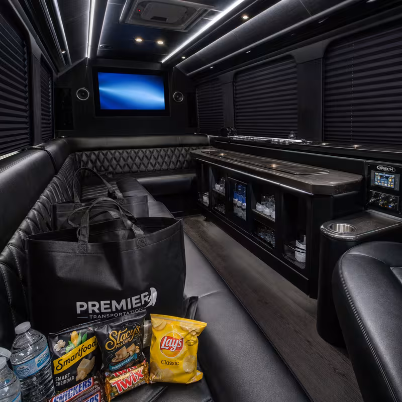 Party bus interior with wraparound leather seating and LED lighting in San Diego
